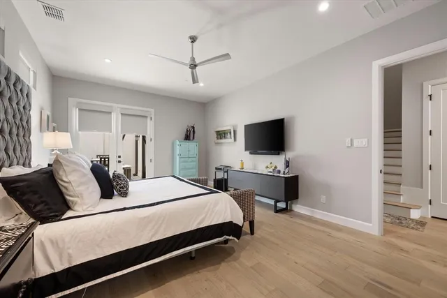 a bedroom with a bed flat screen tv and a couch