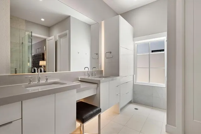 a spacious bathroom with a granite countertop sink a mirror and a