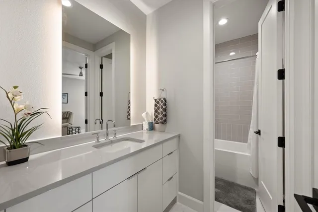 a bathroom with a shower sink and mirror