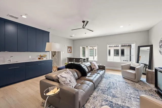 a living room with furniture ceiling fan and a rug