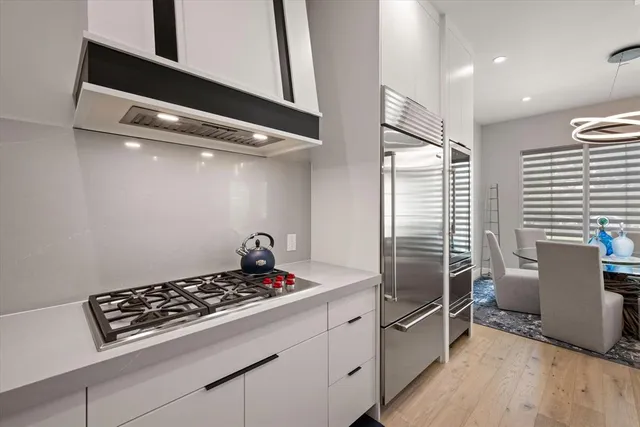 a kitchen with granite countertop a stove and a refrigerator