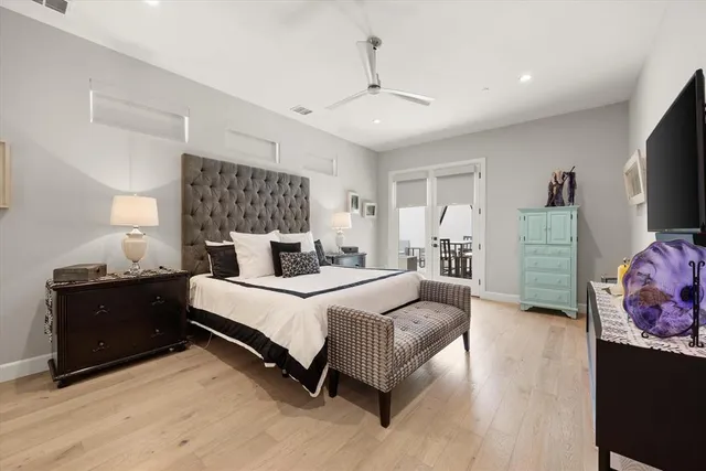 a spacious bedroom with a bed and dresser