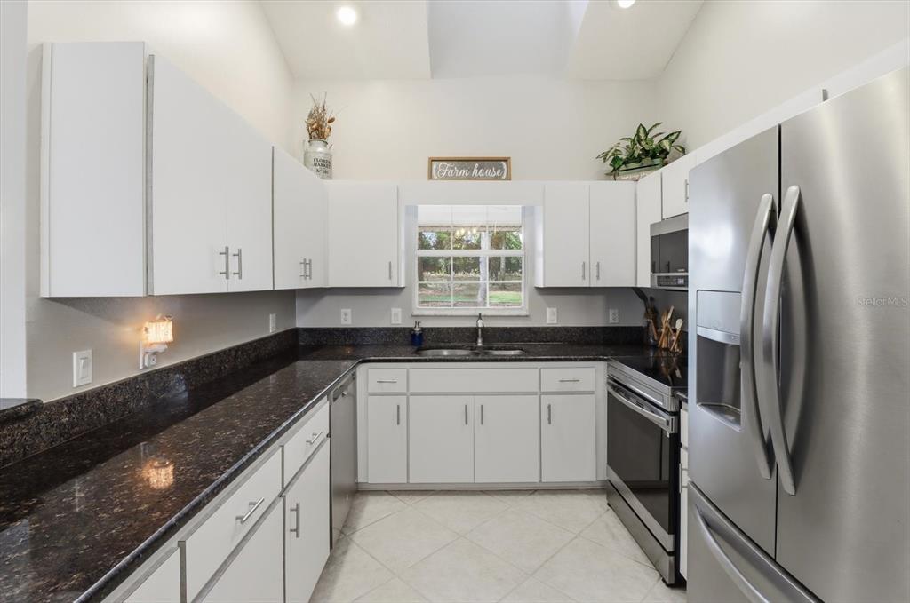3189 South Graymor Path Inverness, FL 34450 - Photo 11 of 46 a kitchen with stainless steel appliances granite countertop a sink and a refrigerator
