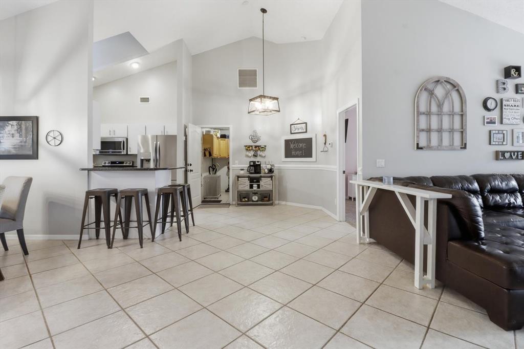 3189 South Graymor Path Inverness, FL 34450 - Photo 16 of 46 a kitchen with stainless steel appliances kitchen island granite countertop a stove a sink a dining table and chairs
