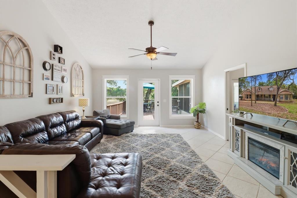 3189 South Graymor Path Inverness, FL 34450 - Photo 17 of 46 a living room with furniture a flat screen tv and a fireplace