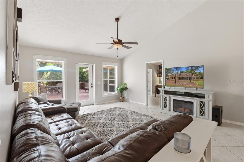 3189 South Graymor Path Inverness, FL 34450 - Photo 18 of 46 a living room with furniture a flat screen tv and a fireplace