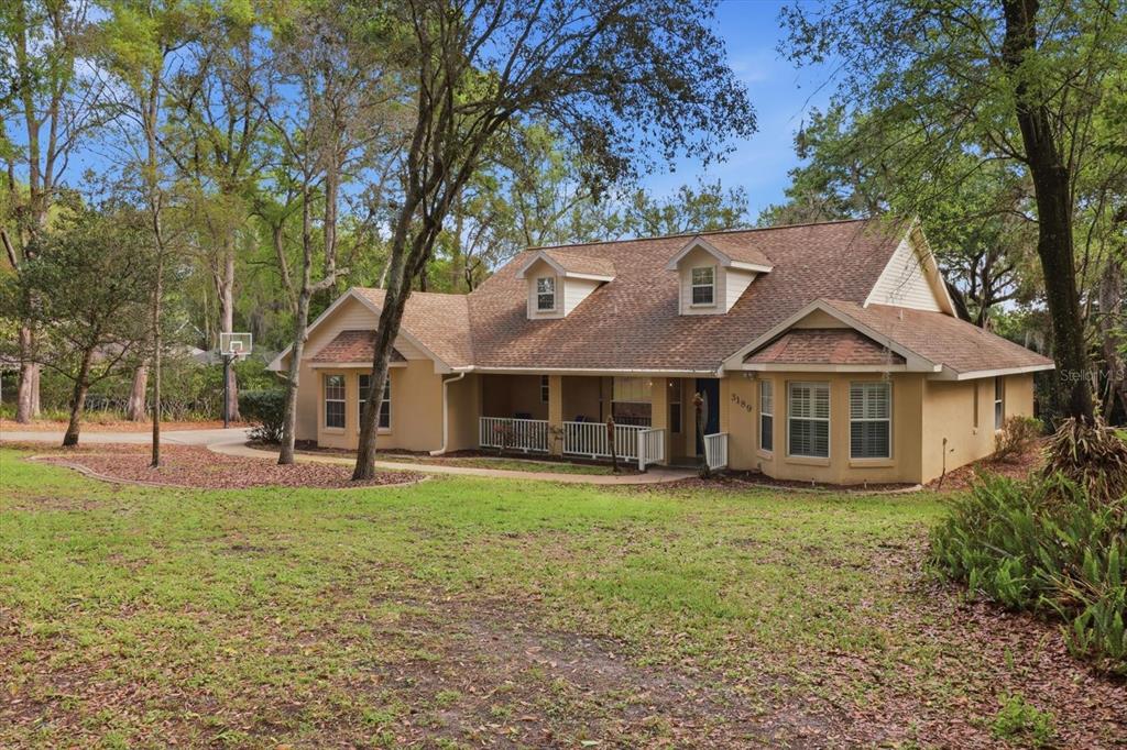 3189 South Graymor Path Inverness, FL 34450 - Photo 2 of 46 front view of a house with a yard