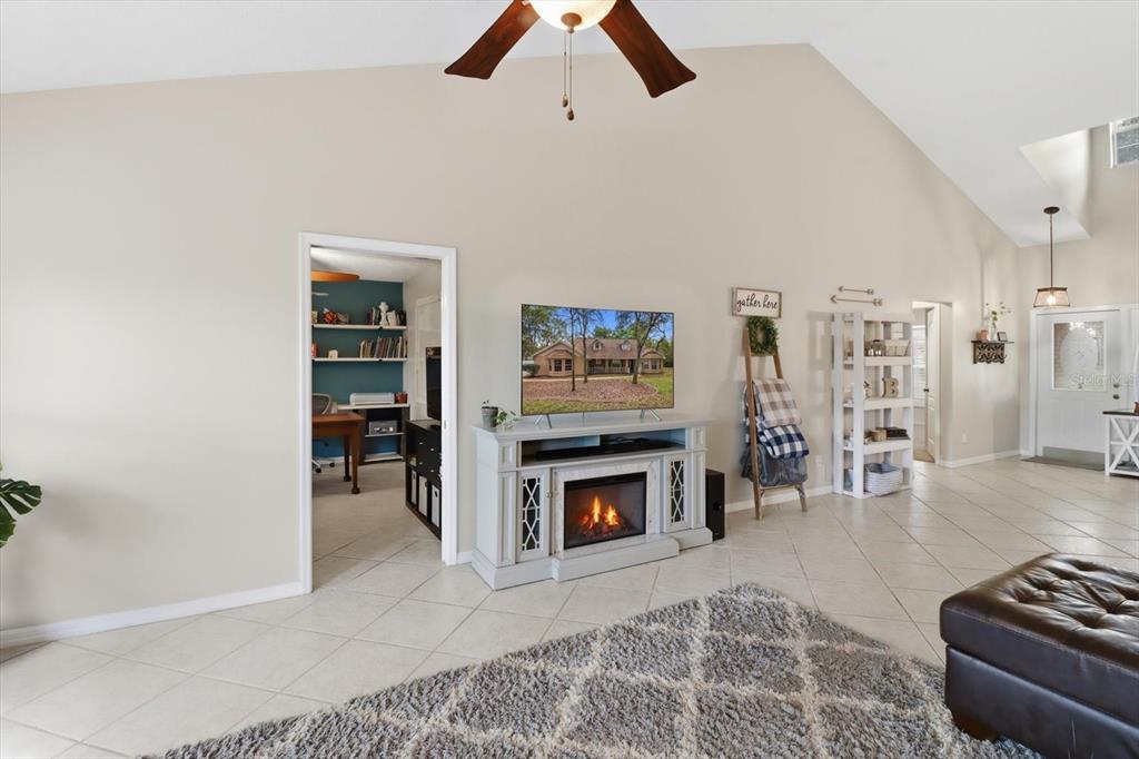 3189 South Graymor Path Inverness, FL 34450 - Photo 21 of 46 a living room with furniture and a fireplace
