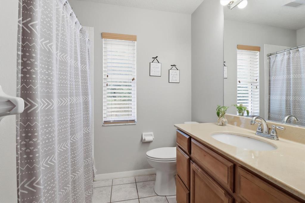 3189 South Graymor Path Inverness, FL 34450 - Photo 24 of 46 a bathroom with a granite countertop sink a toilet and a mirror