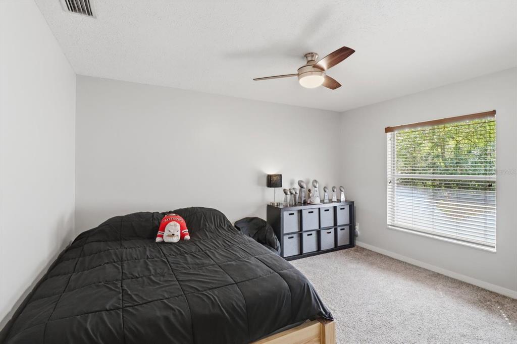 3189 South Graymor Path Inverness, FL 34450 - Photo 25 of 46 a bedroom with a bed and a chandelier