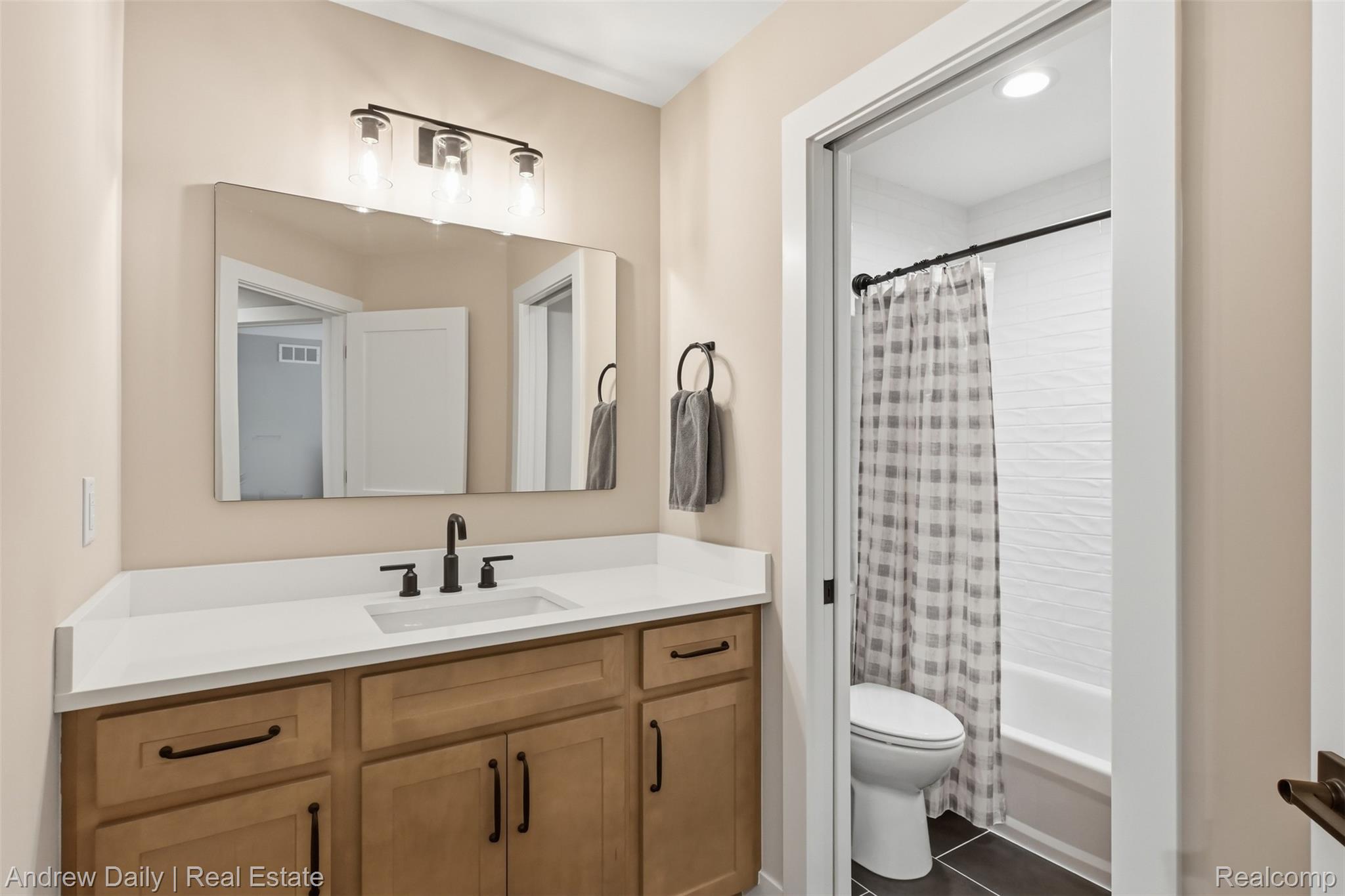 4661 Spears Road Pinckney, MI 48169 - Photo 31 of 56 Bathroom featuring a light-toned vanity with a white countertop and an undermount sink
