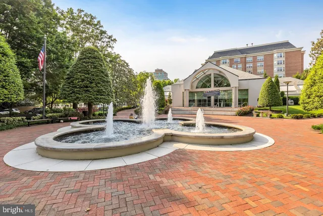 a view of a white house with a swimming pool and yard