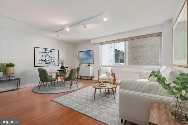 a living room with furniture wooden floor and a window