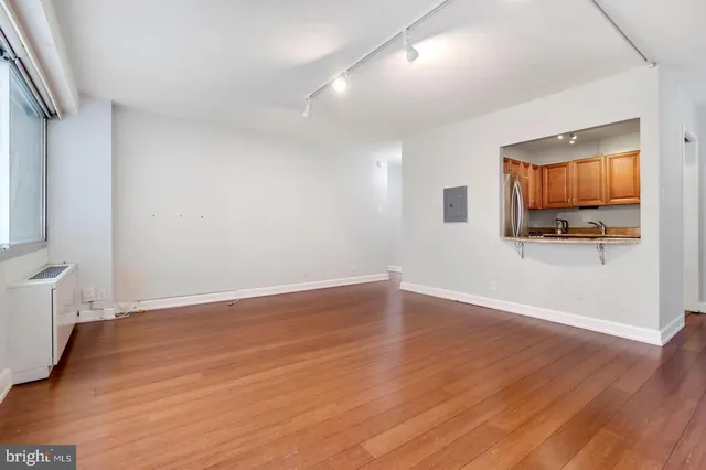a view of room with wooden floor and flat screen tv