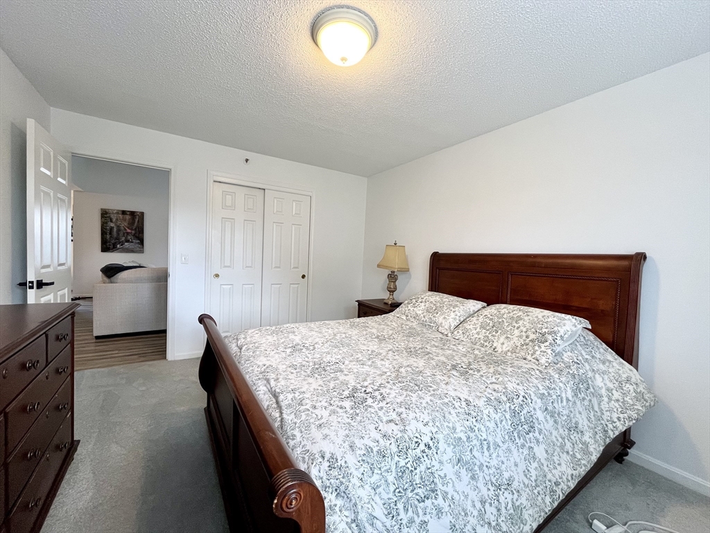 74 Tennis Plaza Road, Unit 34 Dracut, MA 01826 - Photo 11 of 25 a bedroom with bed and window