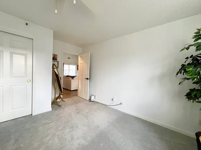 an empty room with windows and painted walls