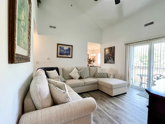 a living room with couches and painting on the wall