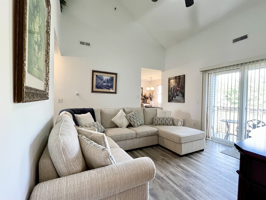 74 Tennis Plaza Road, Unit 34 Dracut, MA 01826 - Photo 2 of 25 a living room with couches and painting on the wall