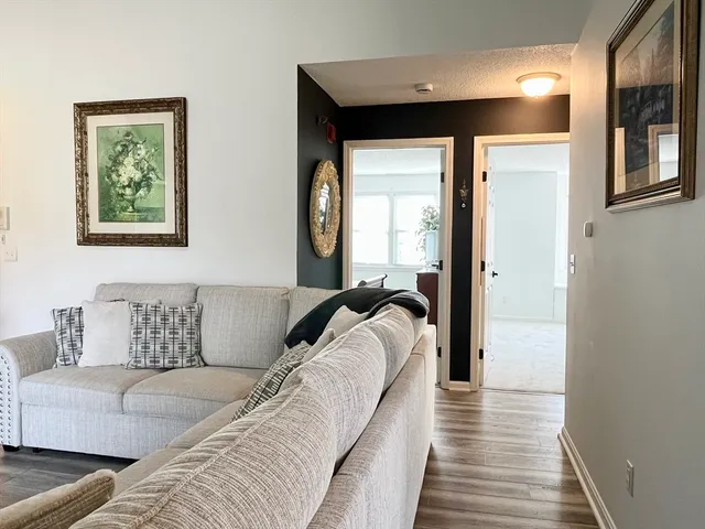 a hallway with a couch and a window