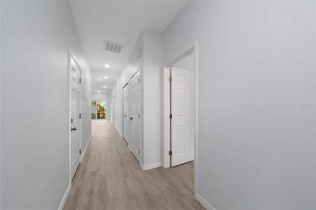 a view of a hallway with wooden floor