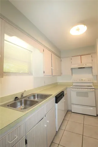 a kitchen with a sink cabinets and window