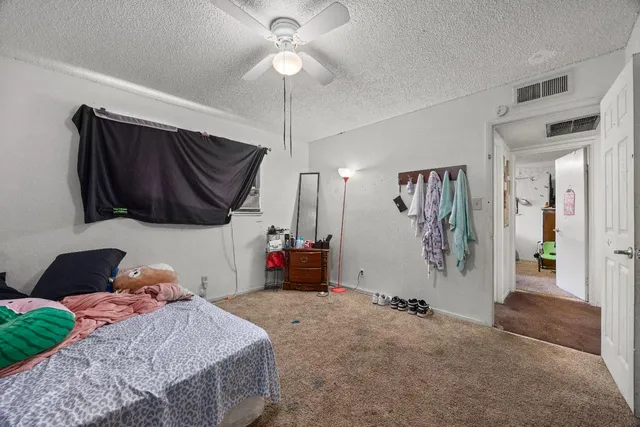 a bedroom with a bed and a mirror on dresser
