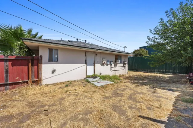 a view of a house with backyard sitting area and swimming pool