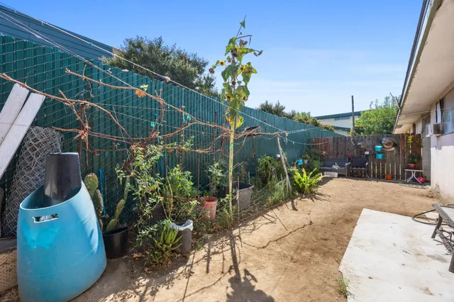 a view of a house with a yard and sitting area
