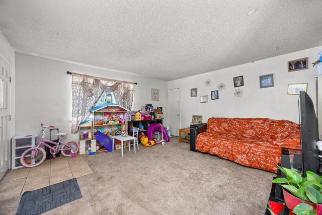 a bedroom with furniture and a flat screen tv