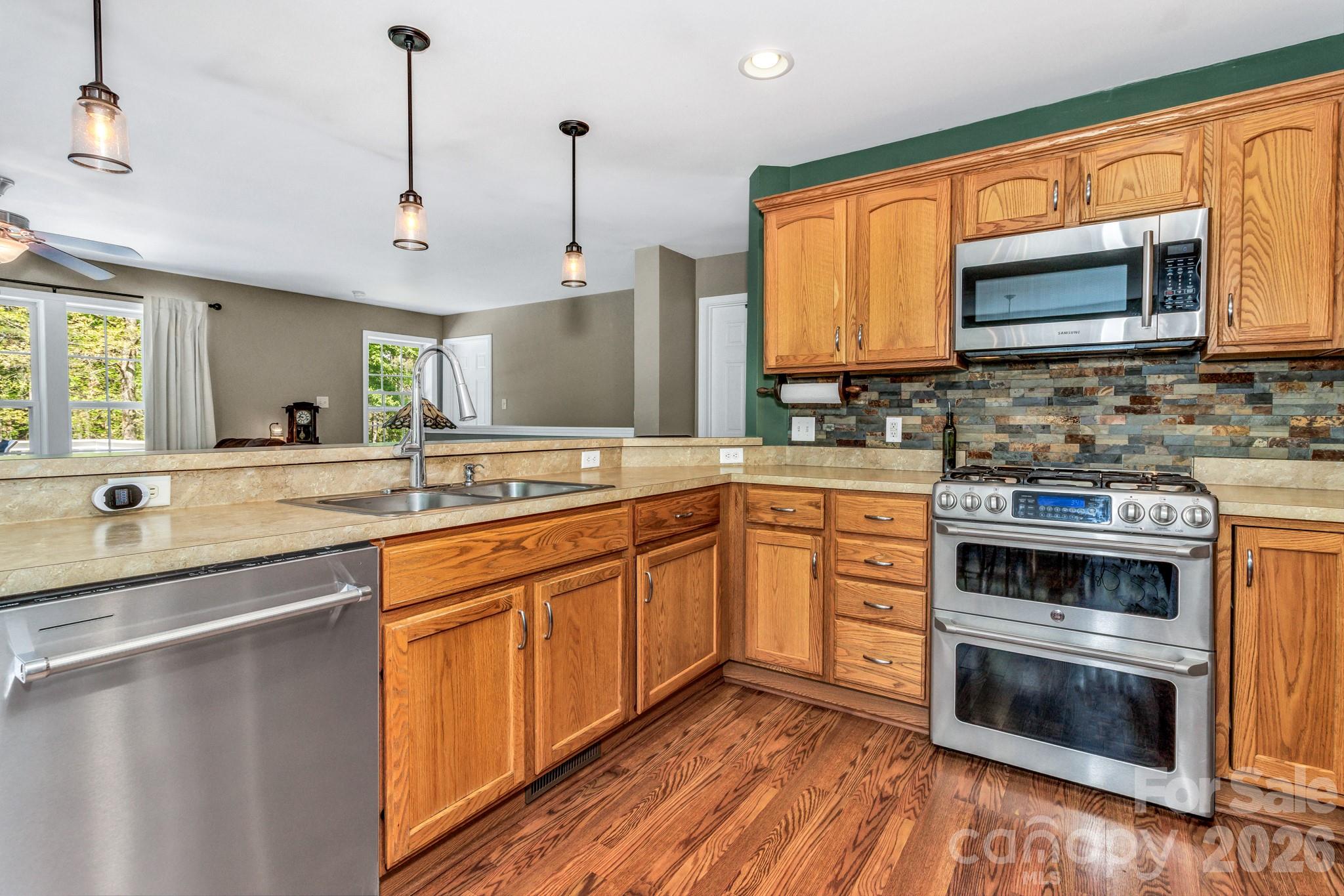 152 Joe Jenkins Road Fairview, NC 28730 - Photo 11 of 44 a kitchen with stainless steel appliances granite countertop a sink and a stove
