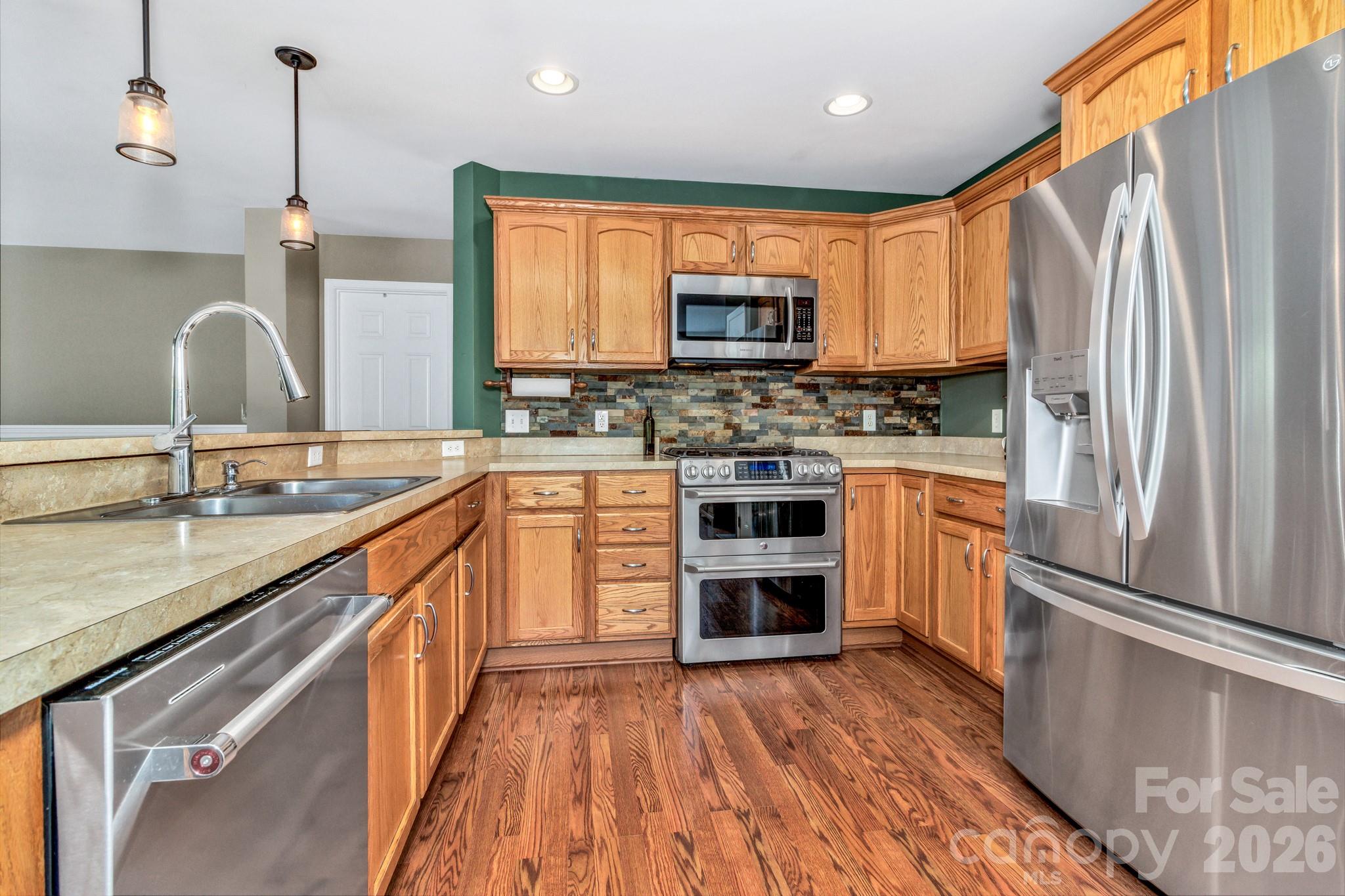 152 Joe Jenkins Road Fairview, NC 28730 - Photo 12 of 44 a kitchen with stainless steel appliances granite countertop a refrigerator a stove top oven a sink and dishwasher
