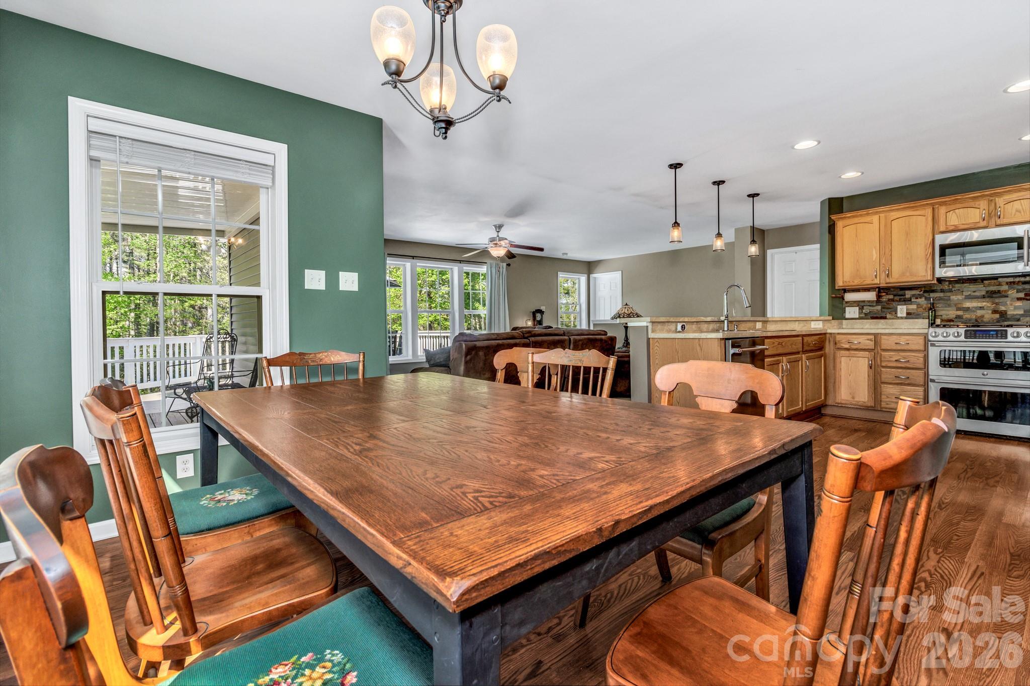 152 Joe Jenkins Road Fairview, NC 28730 - Photo 16 of 44 a room with stainless steel appliances kitchen island granite countertop a table chairs and a refrigerator