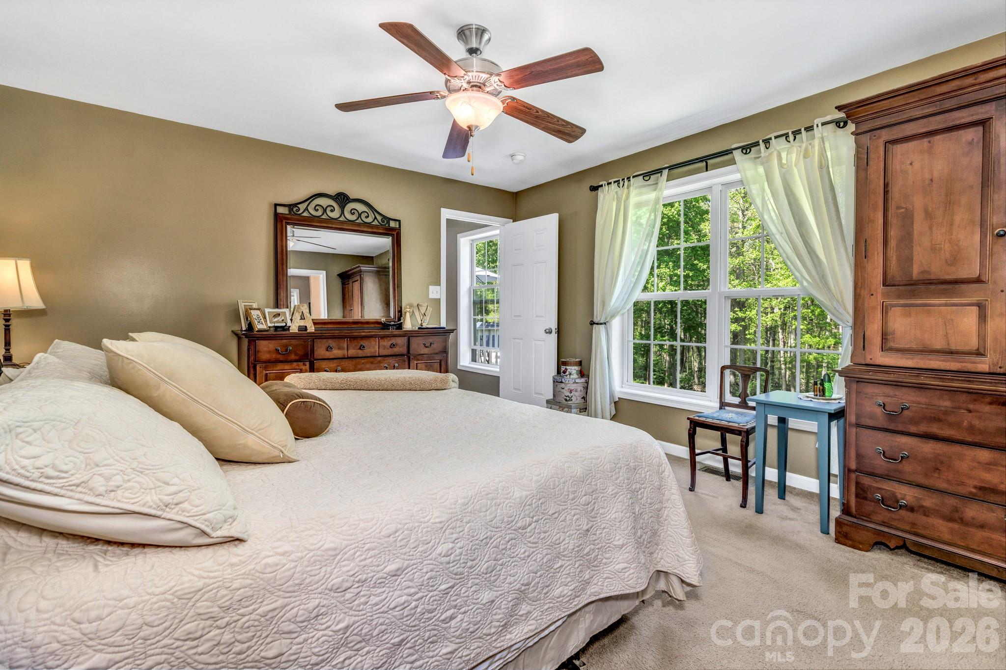152 Joe Jenkins Road Fairview, NC 28730 - Photo 19 of 44 a bedroom with a large bed and a large window