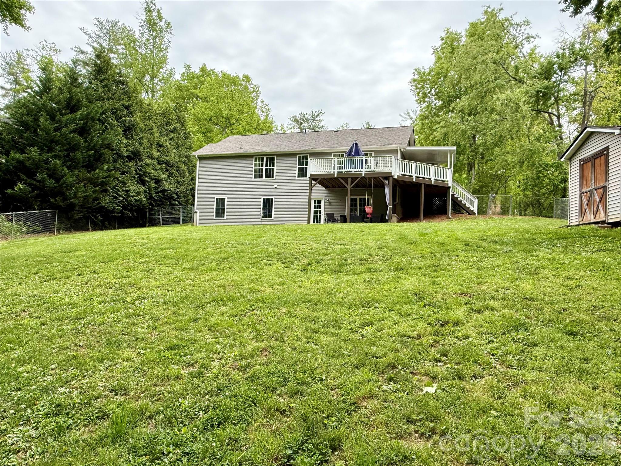 152 Joe Jenkins Road Fairview, NC 28730 - Photo 2 of 44 a house with a big yard and large trees