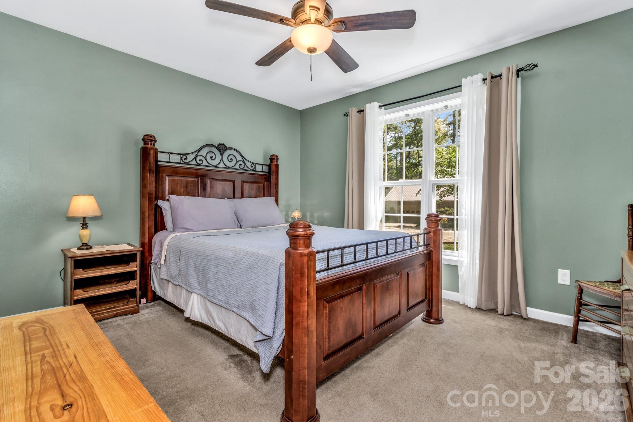 152 Joe Jenkins Road Fairview, NC 28730 - Photo 22 of 44 a bed room with a bed and a chandelier