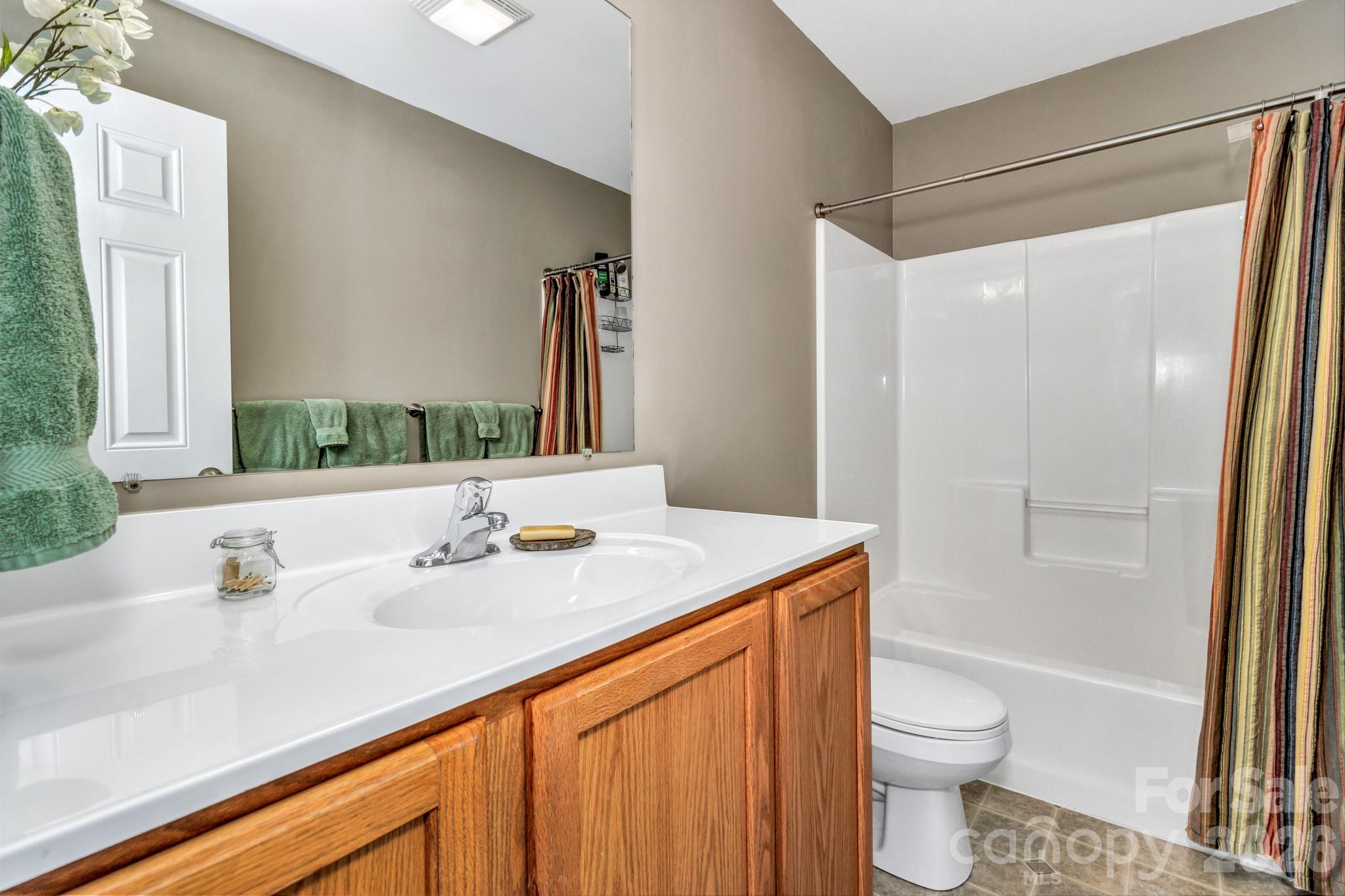 152 Joe Jenkins Road Fairview, NC 28730 - Photo 23 of 44 a bathroom with a granite countertop sink toilet and shower