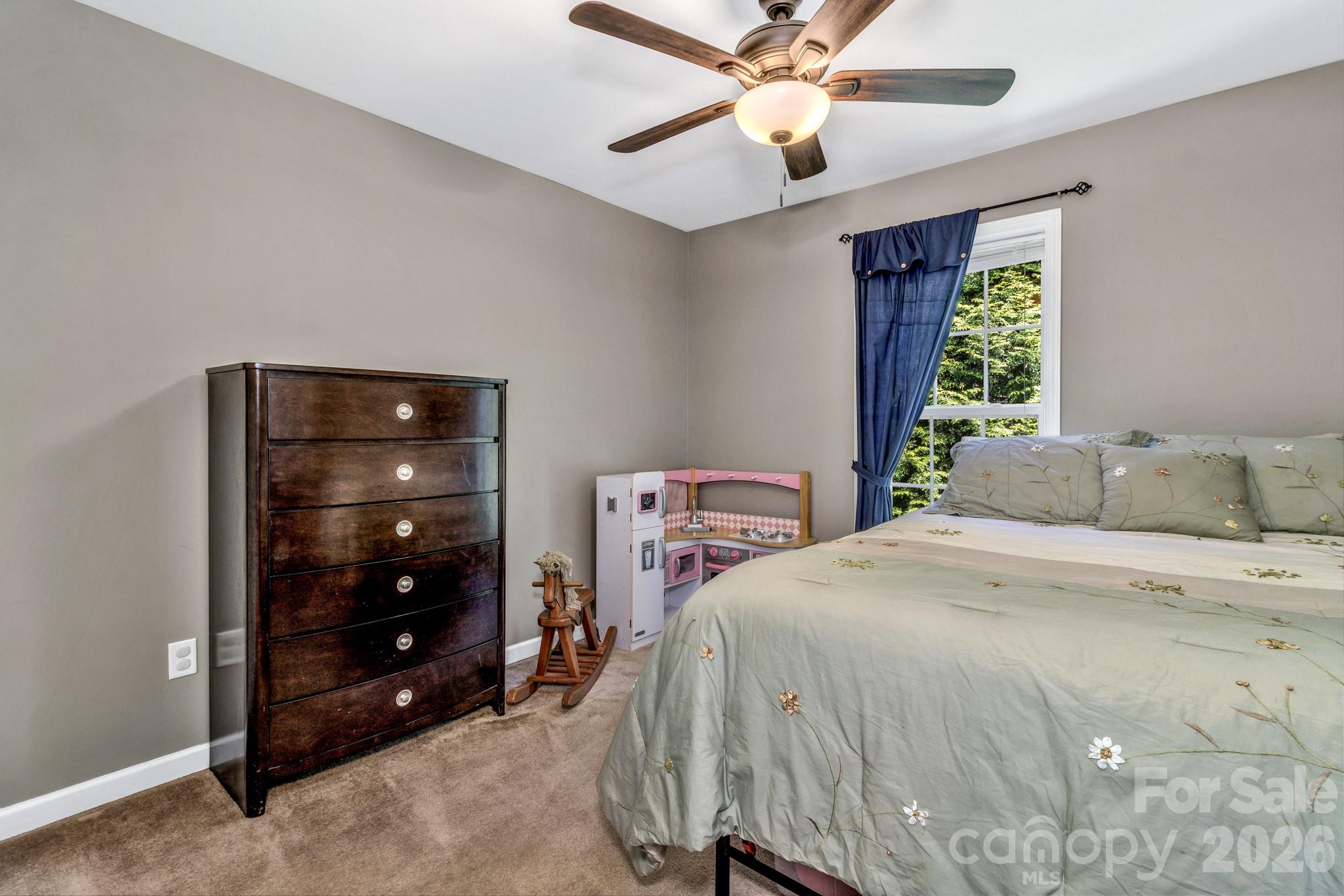 152 Joe Jenkins Road Fairview, NC 28730 - Photo 24 of 44 a bedroom with a bed and a mirror