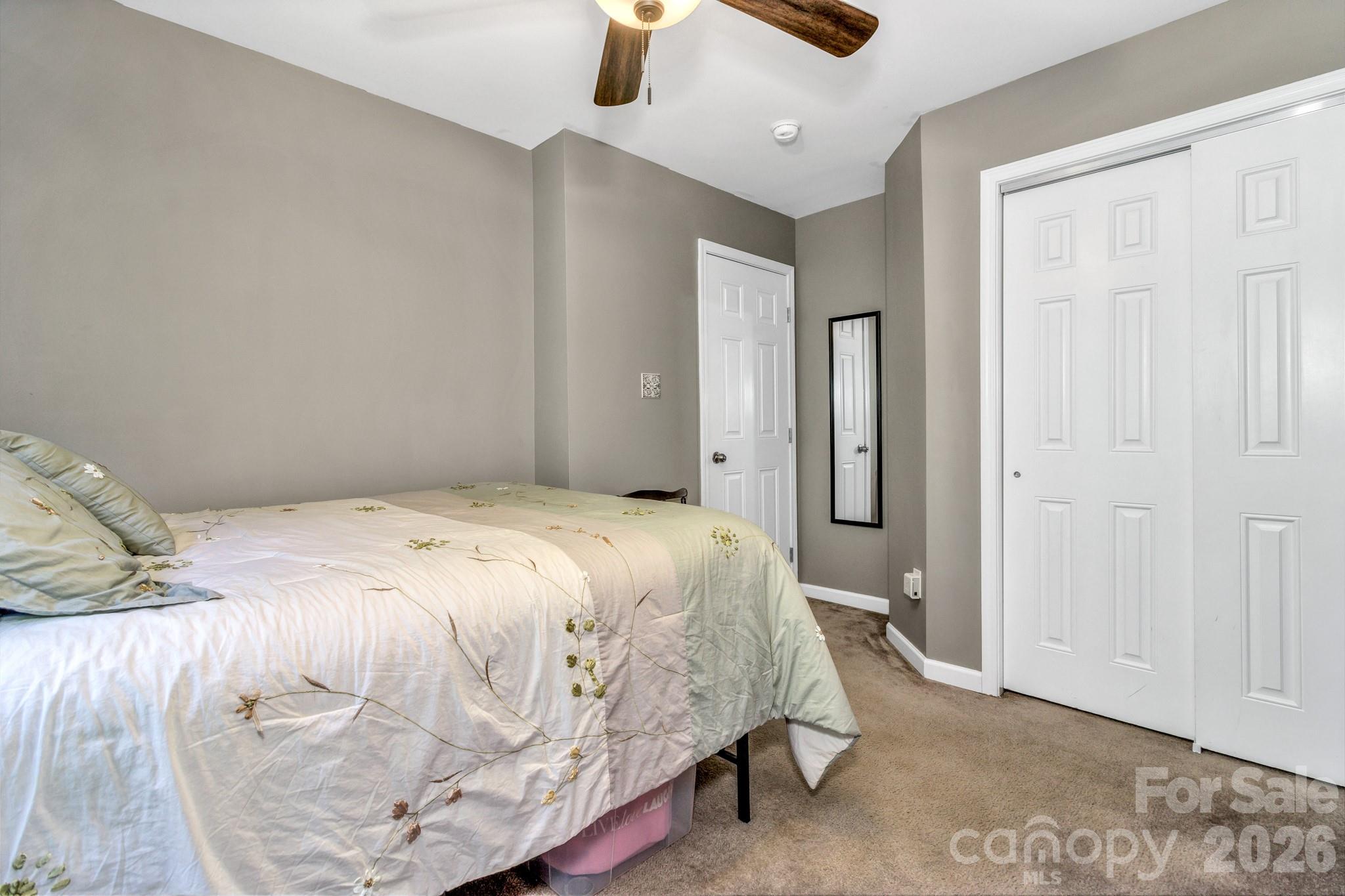 152 Joe Jenkins Road Fairview, NC 28730 - Photo 25 of 44 a bedroom with a bed and a walk in closet