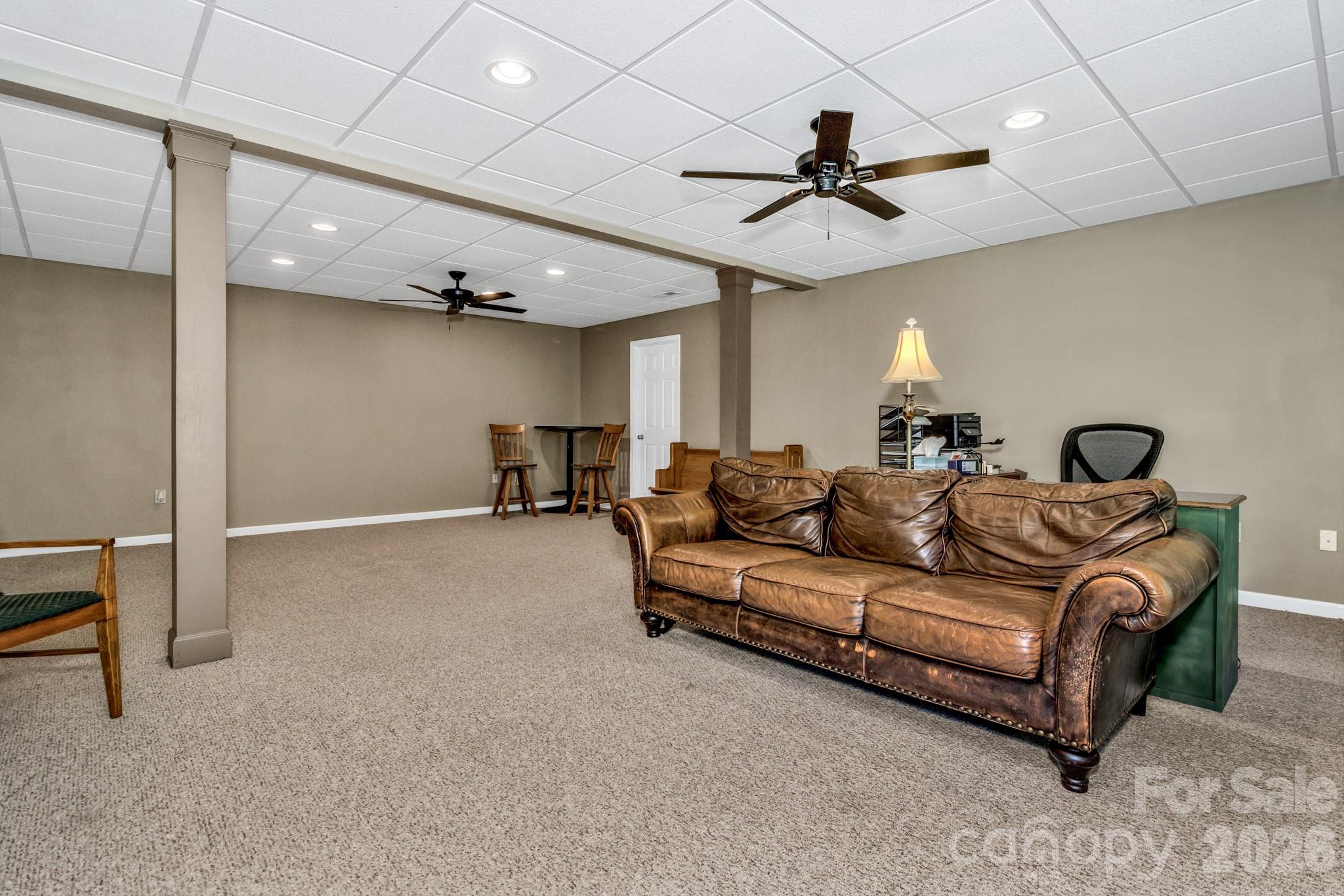152 Joe Jenkins Road Fairview, NC 28730 - Photo 27 of 44 a living room with furniture and a ceiling fan