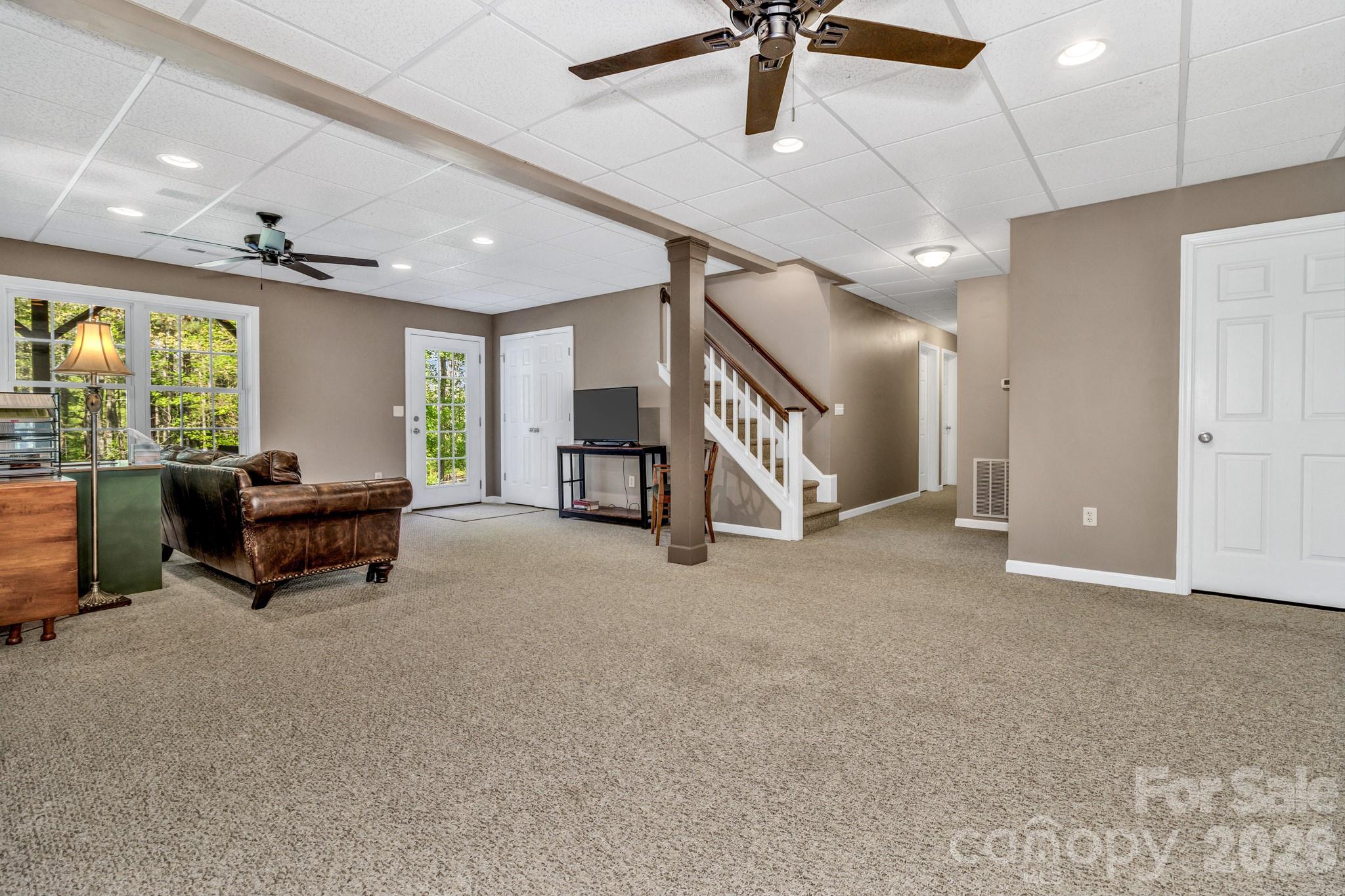 152 Joe Jenkins Road Fairview, NC 28730 - Photo 28 of 44 a living room with furniture and a flat screen tv