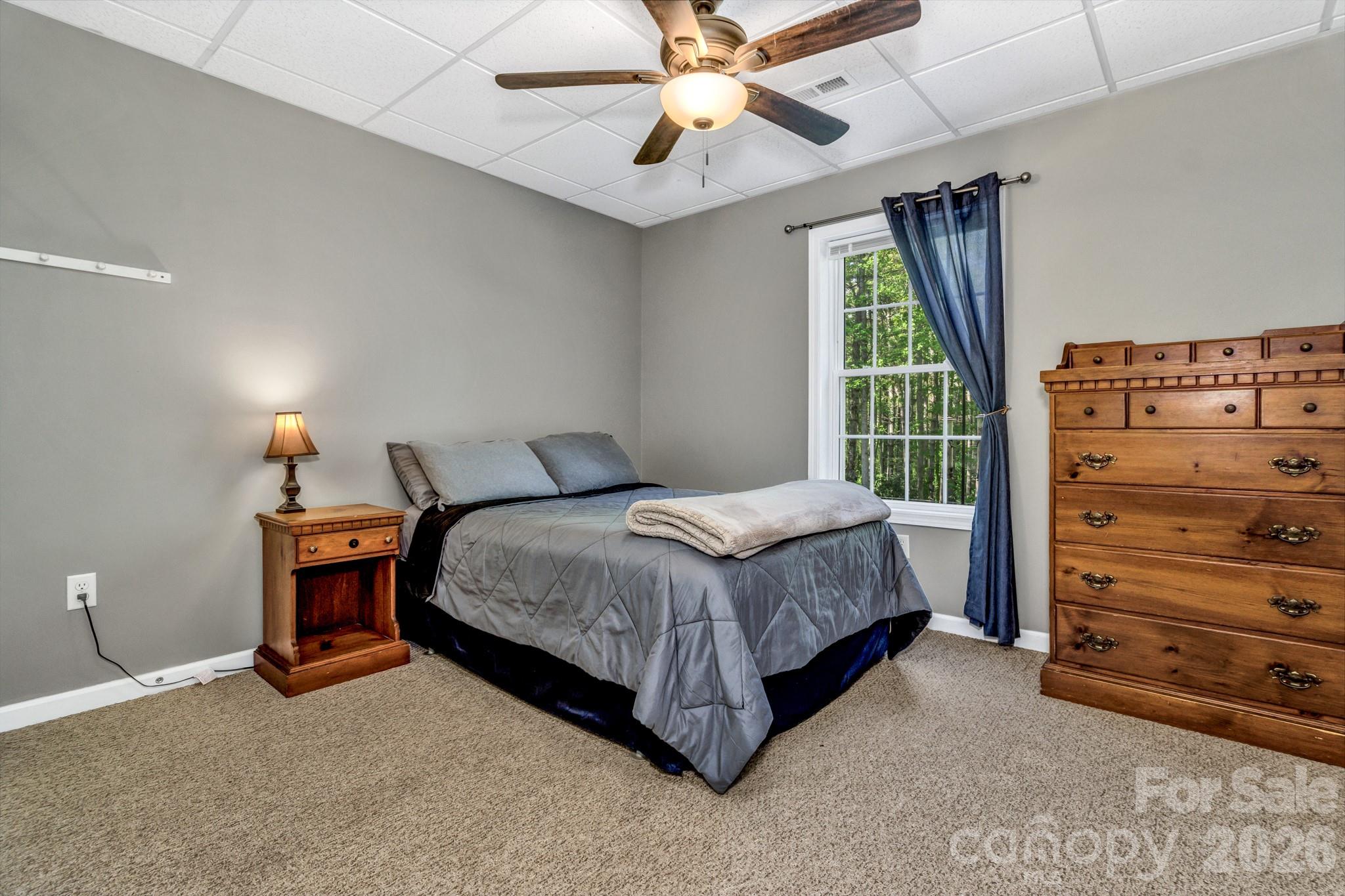 152 Joe Jenkins Road Fairview, NC 28730 - Photo 29 of 44 a bedroom with a bed and a dresser