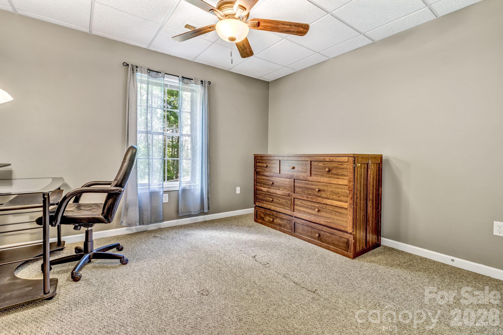 152 Joe Jenkins Road Fairview, NC 28730 - Photo 31 of 44 a view of an empty room with window and furniture