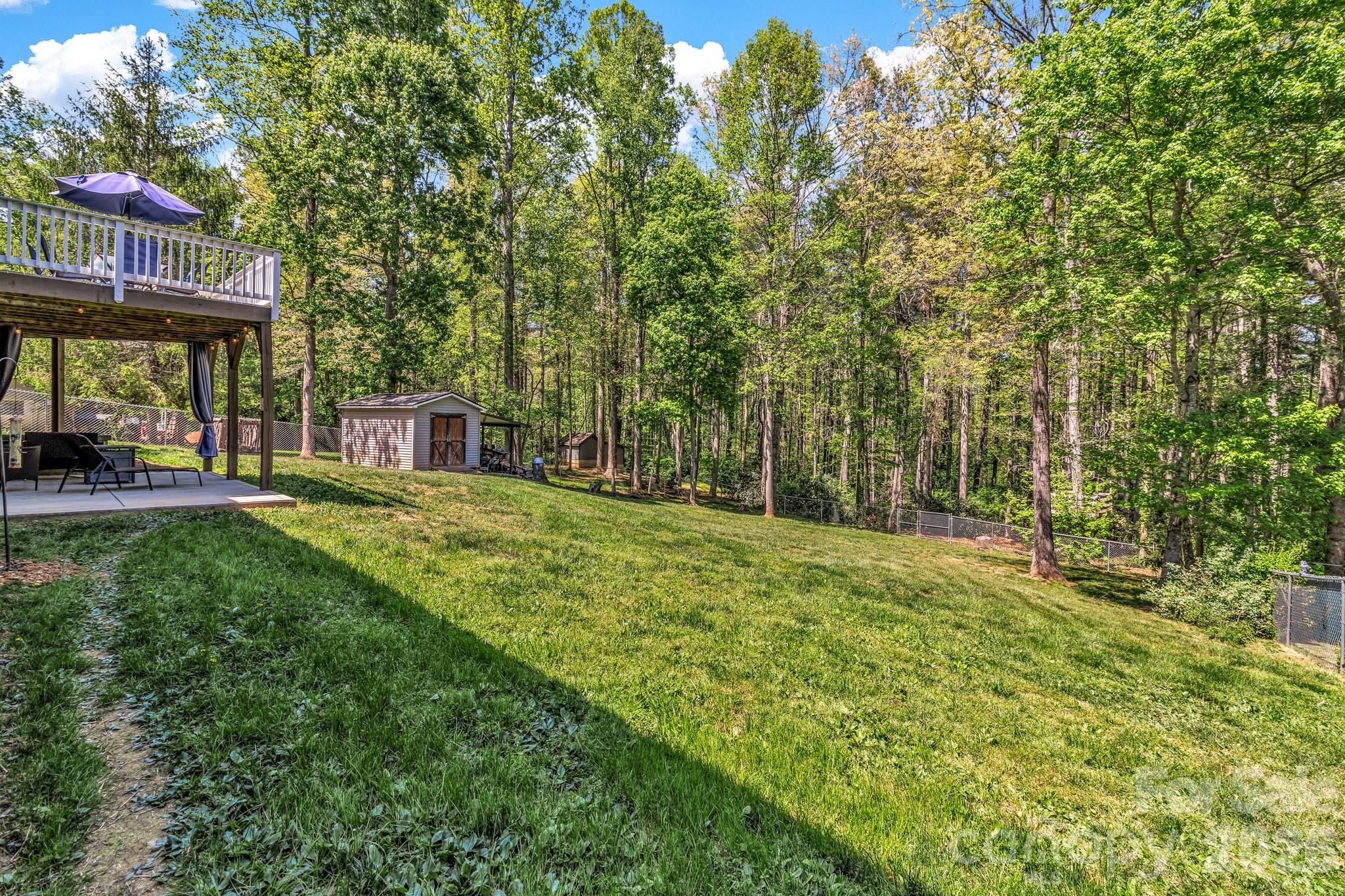 152 Joe Jenkins Road Fairview, NC 28730 - Photo 34 of 44 a view of a house with backyard and sitting area