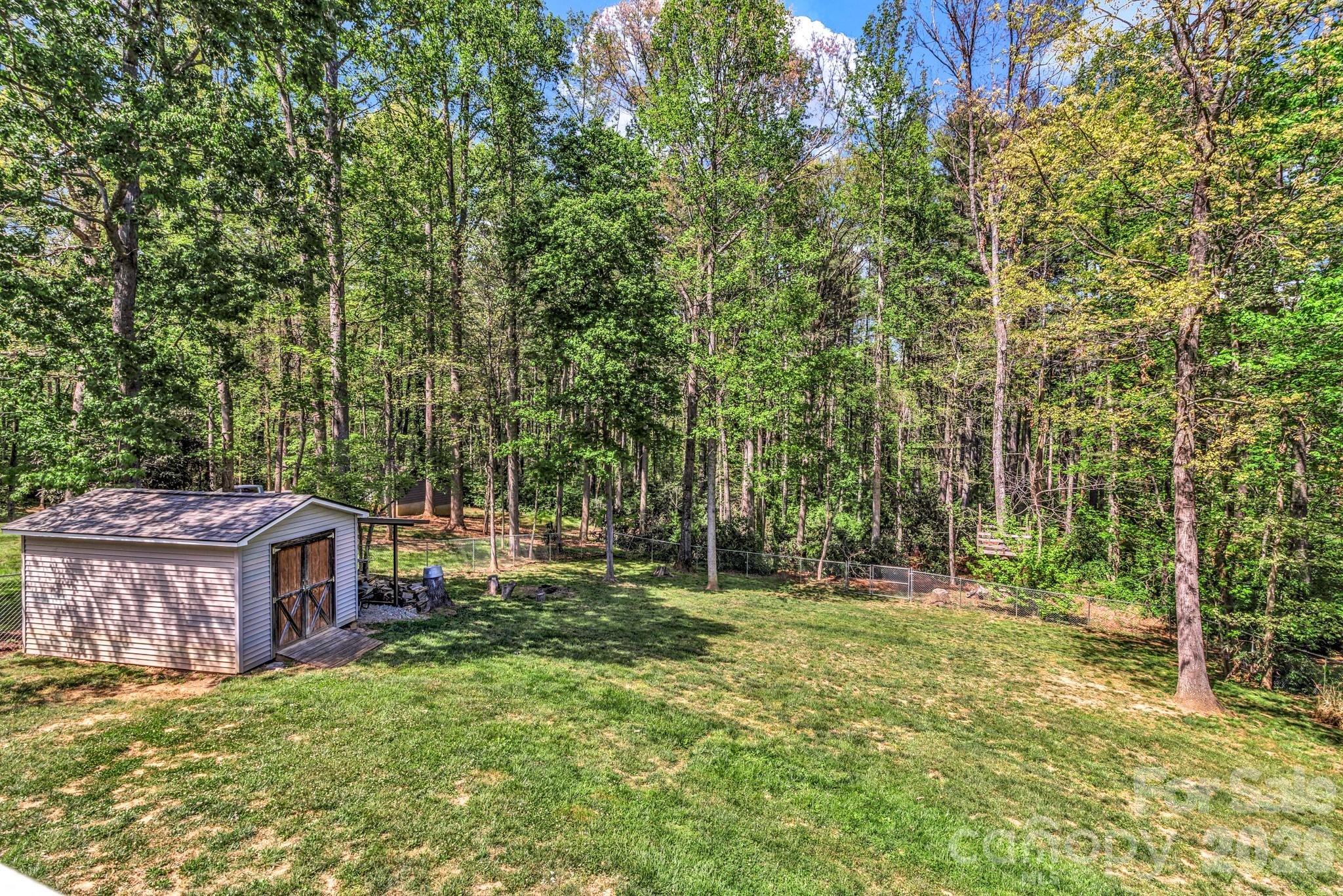 152 Joe Jenkins Road Fairview, NC 28730 - Photo 36 of 44 a backyard of a house with lots of green space and fountain