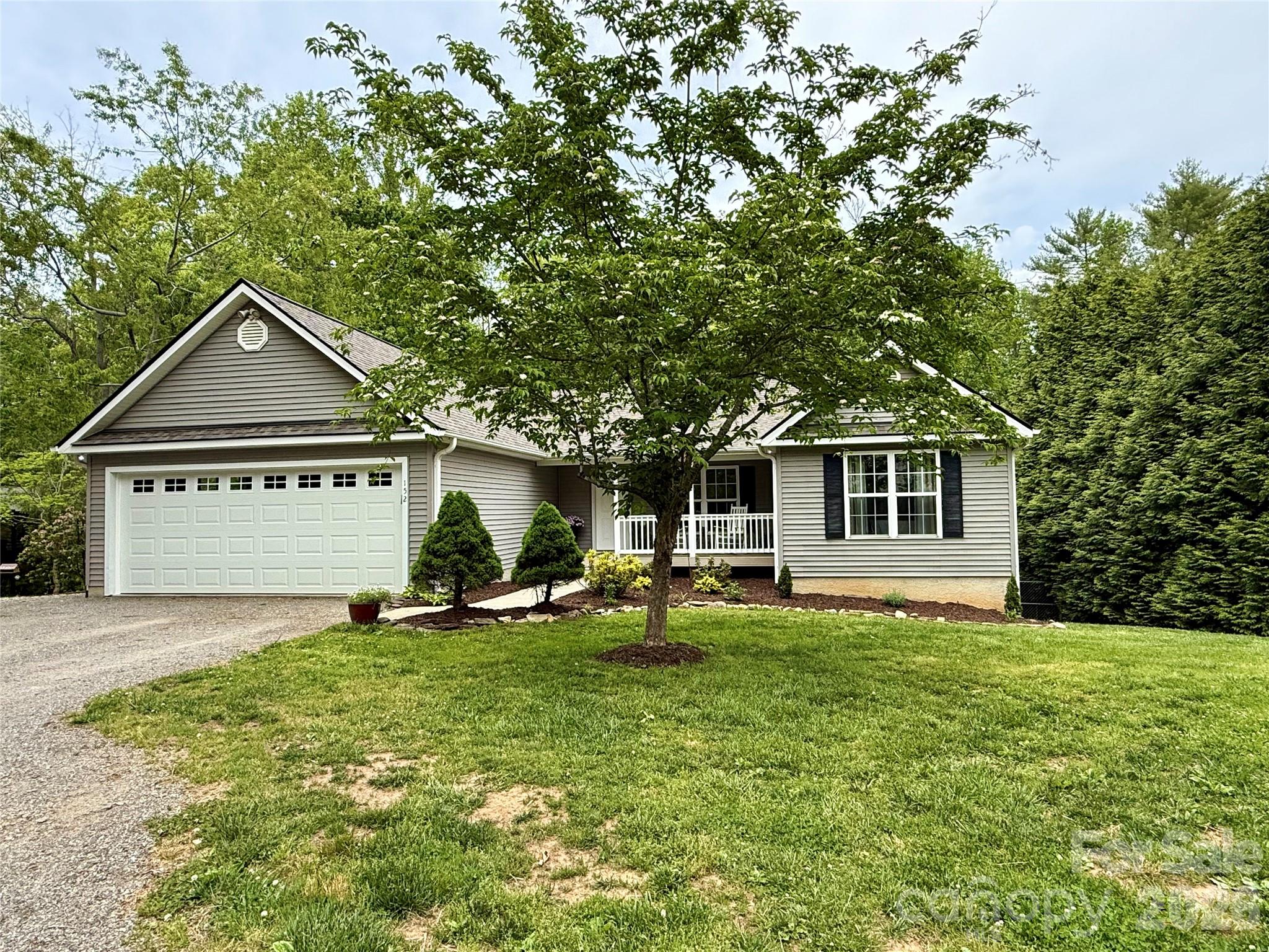 152 Joe Jenkins Road Fairview, NC 28730 - Photo 40 of 44 a front view of a house with a yard and trees