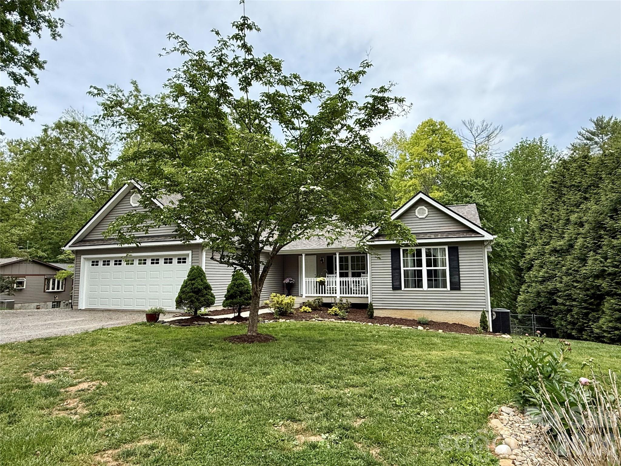 152 Joe Jenkins Road Fairview, NC 28730 - Photo 42 of 44 a front view of a house with a garden