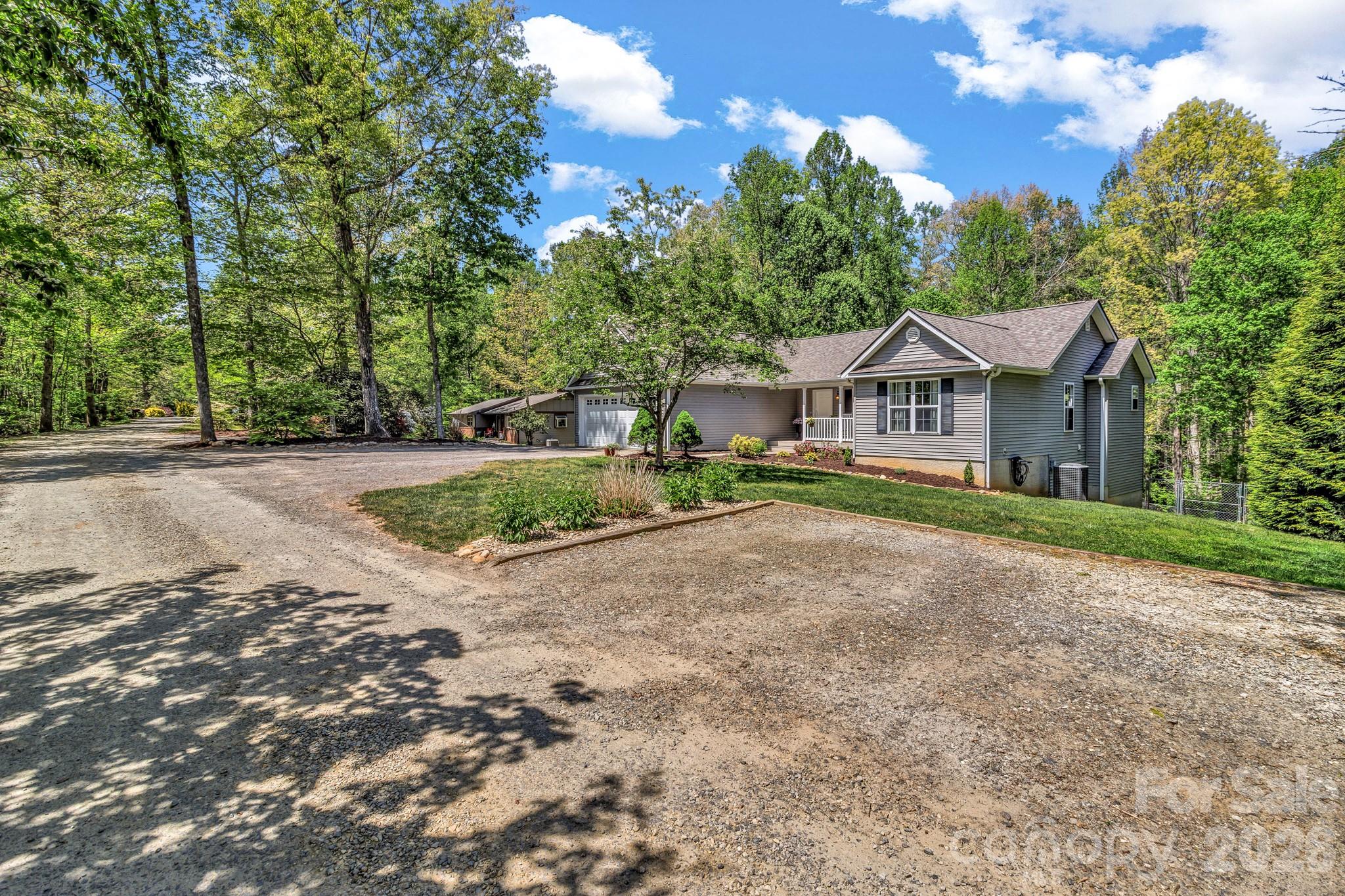 152 Joe Jenkins Road Fairview, NC 28730 - Photo 43 of 44 a front view of a house with a yard and trees