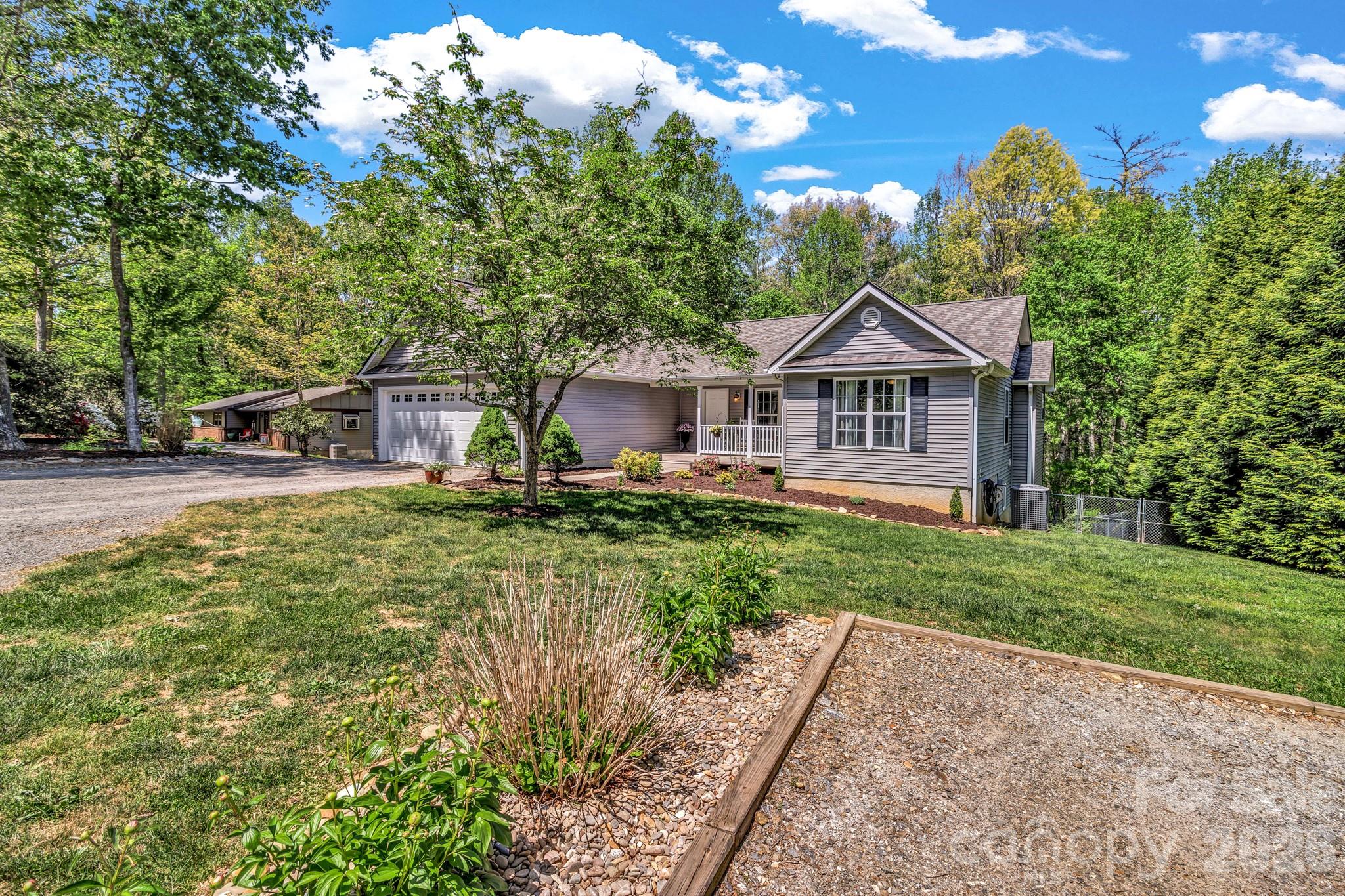 152 Joe Jenkins Road Fairview, NC 28730 - Photo 5 of 44 a front view of a house with garden