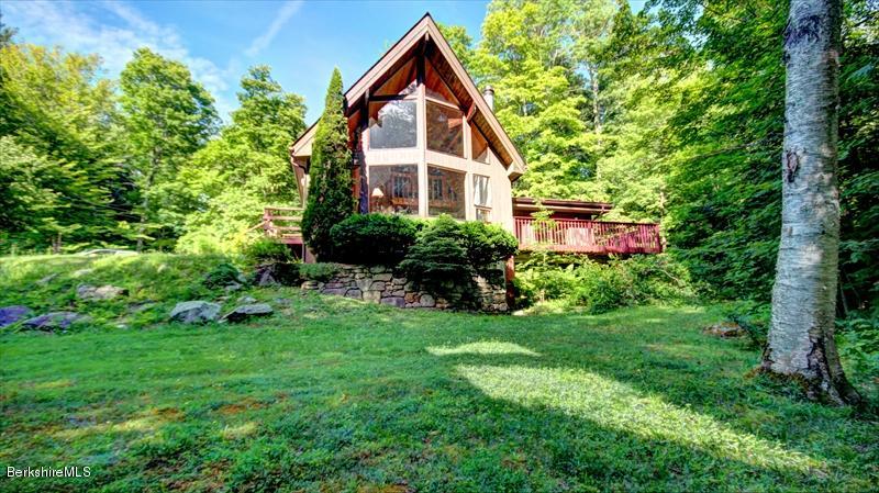517 Dimmock Road Otis, MA 01253 - Photo 1 of 21 a view of a house with a yard and sitting area
