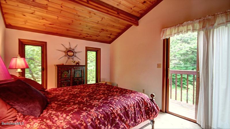 517 Dimmock Road Otis, MA 01253 - Photo 15 of 21 a bed sitting in a bedroom next to a window